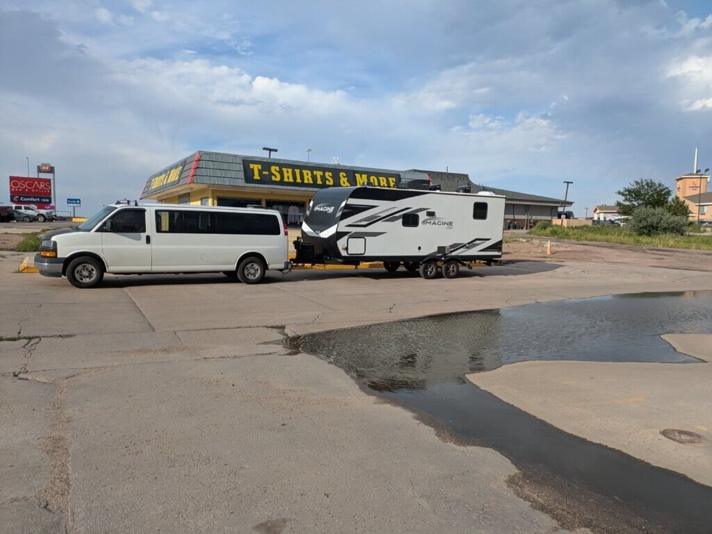 Van and Camper sitting in front of a T-shirt store in Limon, CO