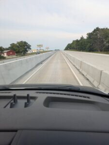 View of narrow road with concrete sides.