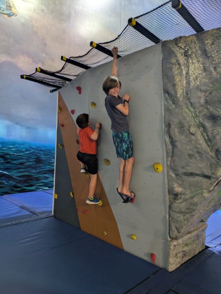 2 boys on climbing wall display