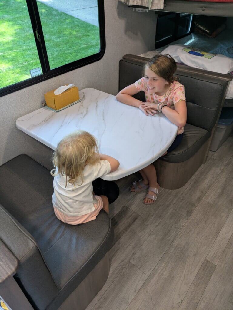 2 girls sitting at table