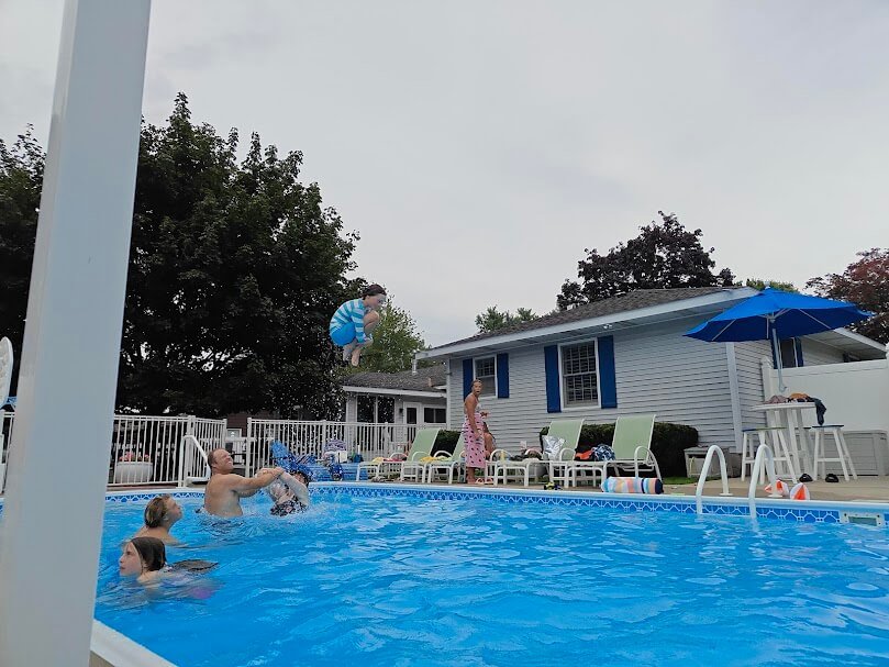 Kid cannonballing into pool