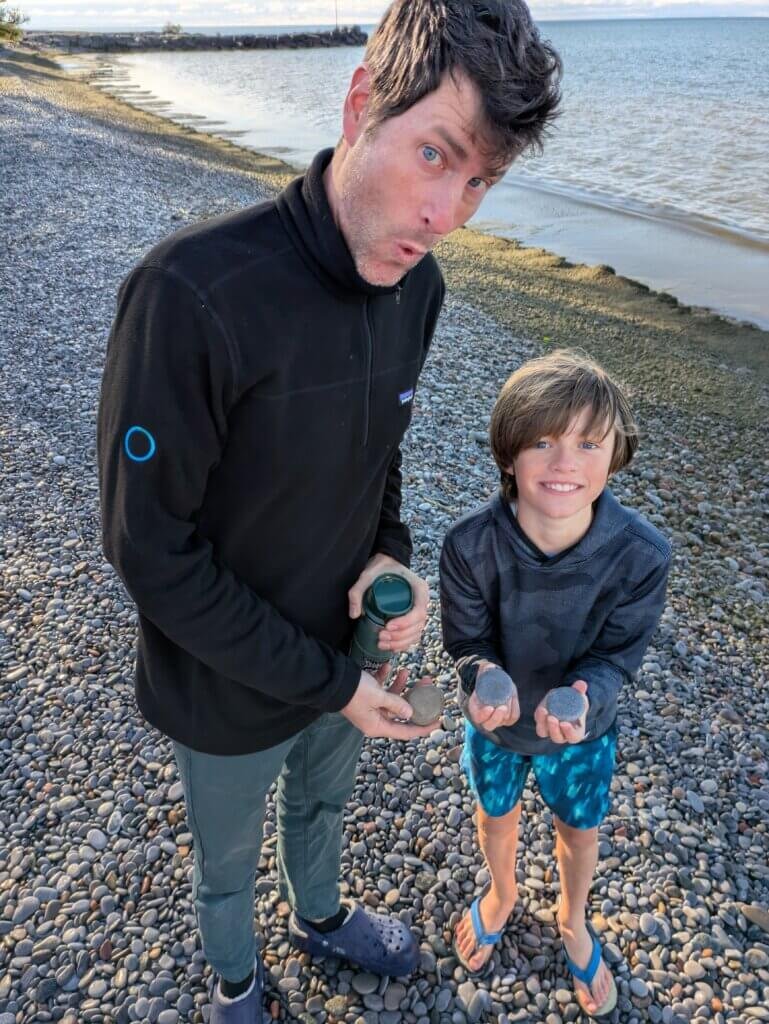 Man and boy showing off good skipping stones